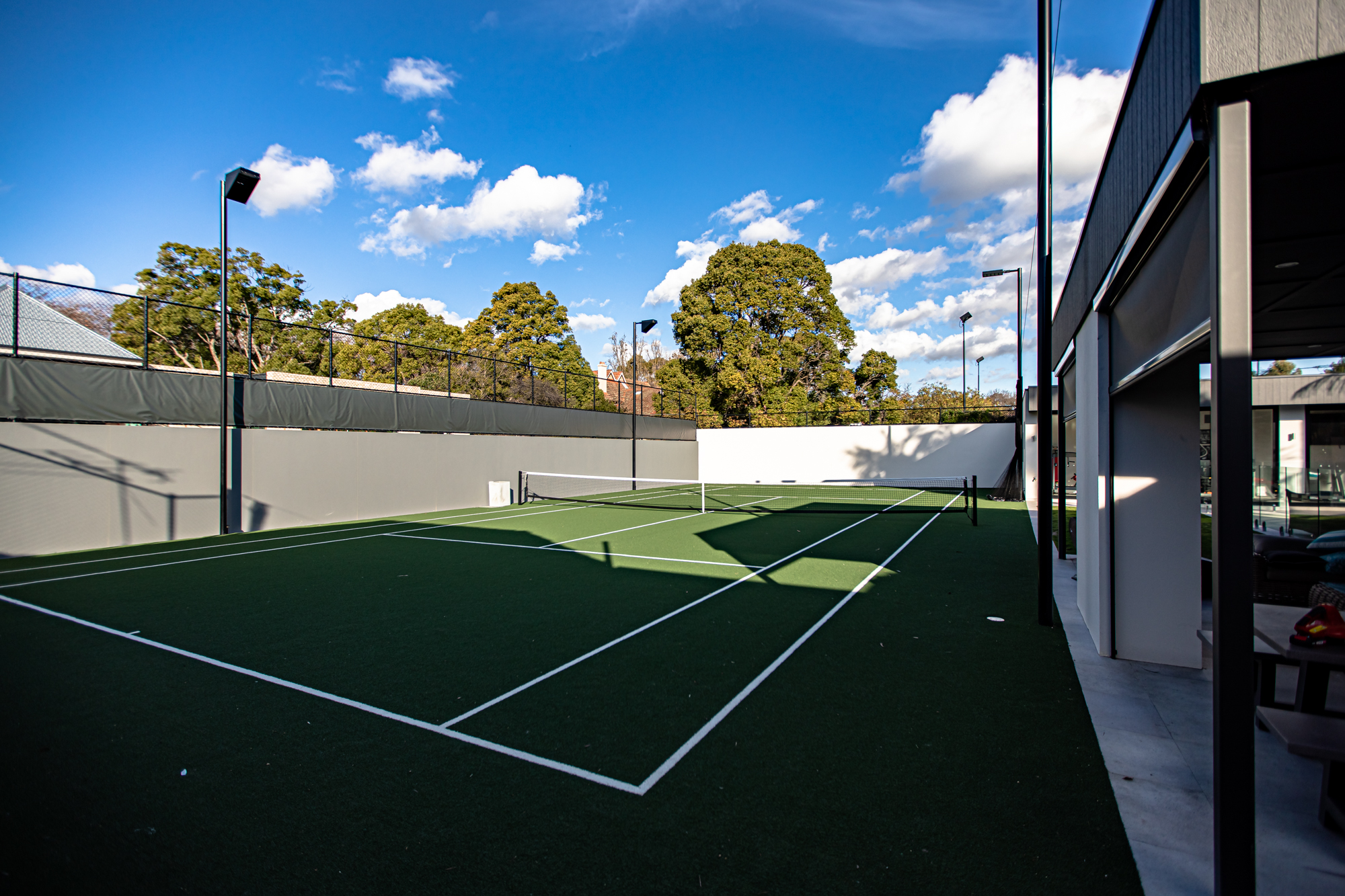 Luxury residential tennis court in Unley Park by Built Solutions